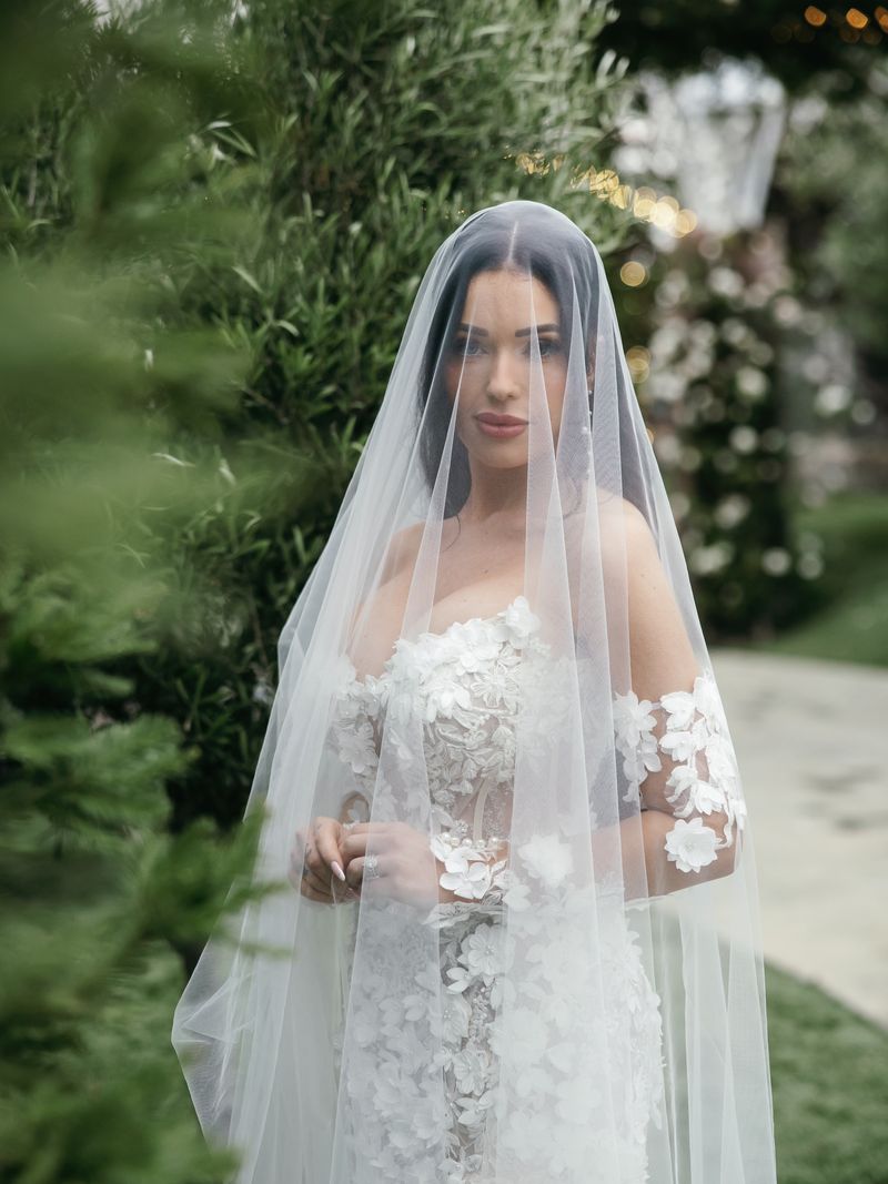 Bride beneath her veil in the garden